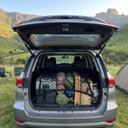 Cargo net holding a camping fridge and sleeping bags in a Toyota Fortuner boot in the Drakensberg