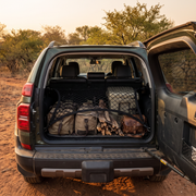 Cargo net securing bags and braai wood in a Toyota Prado boot in the bushveld