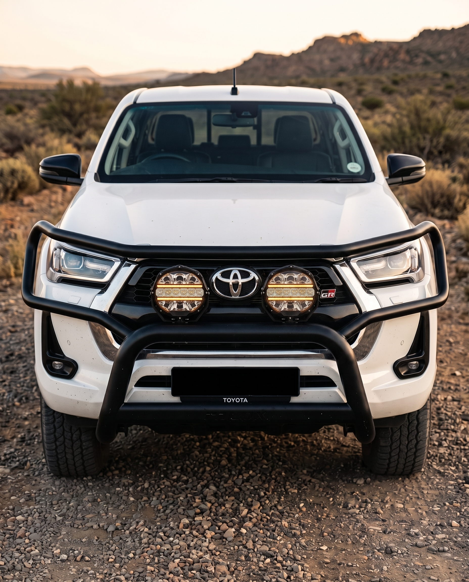 Two Deadtree spotlights on the bull bar of a Toyota Hilux GR, front view in the Karoo