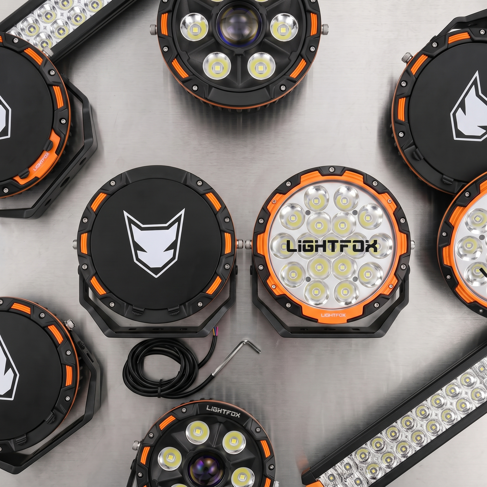 Lightfox LED 4x4 spotlights and light bars flat-lay on a steel table